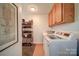 This laundry room offers storage and modern, front-loading washer and dryer at 801 Witmore Rd, Wingate, NC 28174