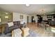 Open-concept living room with hardwood floors connecting to the dining area and kitchen at 801 Witmore Rd, Wingate, NC 28174