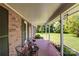 Inviting covered porch with a tiled floor, seating, and views of the front yard at 801 Witmore Rd, Wingate, NC 28174
