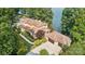 Lakefront home with expansive windows, tile roof, multiple garages, manicured grounds, and waterfront access at 9184 Greenwood Rd, Terrell, NC 28682