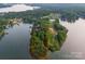 Aerial view of a lakeside property, showcasing wooded lot with a partial red outline and lake views at 9184 Greenwood Rd, Terrell, NC 28682