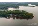 Overhead photograph displays a lakeside property, covered in lush greenery with a red outline to designate property boundaries at 9184 Greenwood Rd, Terrell, NC 28682