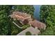 Lakefront home with expansive windows, tile roof, multiple garages, manicured grounds, and waterfront access at 9184 Greenwood Rd, Terrell, NC 28682