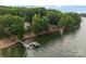 Picturesque lakefront property with a private dock, surrounded by mature trees and offering serene water views at 9184 Greenwood Rd, Terrell, NC 28682