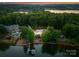 Aerial view of lakeside home with swimming pool, mature trees and private dock at 9184 Greenwood Rd, Terrell, NC 28682