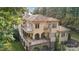 This home's back exterior boasts balconies, covered seating areas, and stone archways at 9184 Greenwood Rd, Terrell, NC 28682