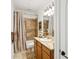 Standard bathroom featuring a shower-tub combo with tile surround, a wooden vanity, and neutral color scheme at 9184 Greenwood Rd, Terrell, NC 28682