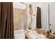 Cozy bathroom featuring tile surround in a shower-tub combo and light-colored walls to maximize brightness at 9184 Greenwood Rd, Terrell, NC 28682