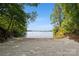 A sandy beach surrounded by a lush green forest and lake access, offering tranquility and natural beauty at 9184 Greenwood Rd, Terrell, NC 28682