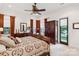 Comfortable bedroom with an ornate wooden bed, dark wood furniture, and windows showcasing the beautiful backyard view at 9184 Greenwood Rd, Terrell, NC 28682
