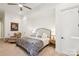 Cozy bedroom with a comfortable chair, lamps, and a bed covered in a soft blanket, complemented by neutral walls at 9184 Greenwood Rd, Terrell, NC 28682