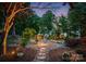 Lush garden with stone pathway leads to a tranquil view, surrounded by manicured greenery and flowers at 9184 Greenwood Rd, Terrell, NC 28682