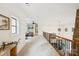 Bright hallway boasts natural light, stone accent wall, and an intricate wrought iron railing at 9184 Greenwood Rd, Terrell, NC 28682