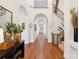 Elegant hallway featuring arched doorways, hardwood floors, and decorative sconces at 9184 Greenwood Rd, Terrell, NC 28682