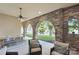 Inviting outdoor patio with stone arches, ceiling fan, and dining and seating areas at 9184 Greenwood Rd, Terrell, NC 28682