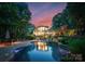Outdoor oasis featuring a large pool, stone waterfall, lounge chairs, and lush landscaping at 9184 Greenwood Rd, Terrell, NC 28682
