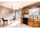 Eat-in kitchen with wood cabinets, laminate floors, and access to outdoor patio area at 102 Brandywine Ne Dr # O-3, Conover, NC 28613