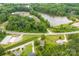Aerial shot capturing the property, nearby lake, road, and buildings surrounded by lush forest at 103 Fleetwood Rd, York, SC 29745
