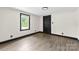 Cozy bedroom with a modern light fixture, wood-look floors, and ample natural light at 103 Fleetwood Rd, York, SC 29745