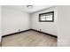 A clean, brightly lit bedroom with simple decor and modern vinyl flooring at 103 Fleetwood Rd, York, SC 29745