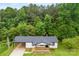 Charming one-story home featuring a wooden porch, carport, and surrounded by lush greenery at 103 Fleetwood Rd, York, SC 29745