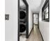 Hallway with laundry hookups with black trim and wood-look floors leading to other rooms at 103 Fleetwood Rd, York, SC 29745