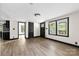 Bright living space with contemporary flooring, black door trim, and multiple entryways at 103 Fleetwood Rd, York, SC 29745