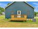 Back deck with a door and two small windows at 105 Churchill Dr, Kings Mountain, NC 28086