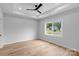 Bright bedroom features hardwood floors, a ceiling fan, and a large window at 105 Churchill Dr, Kings Mountain, NC 28086