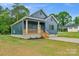 Charming blue home with a wooden porch and a well-maintained front yard at 105 Churchill Dr, Kings Mountain, NC 28086
