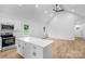 Open kitchen with island, sleek appliances, and an adjacent living area at 105 Churchill Dr, Kings Mountain, NC 28086