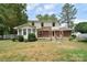 Spacious backyard with a deck, lush greenery, and a privacy fence at 109 Larch Rd, Salisbury, NC 28147