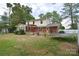 A spacious backyard view featuring a deck, lawn, and a two-story home with brick and vinyl siding at 109 Larch Rd, Salisbury, NC 28147