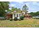 Backyard shot of a home featuring a deck with pergola, vinyl siding and brick details, all in a lush green setting at 109 Larch Rd, Salisbury, NC 28147