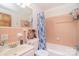 Cozy bathroom with a shower over tub, tiled vanity, mirror, and commode at 109 Larch Rd, Salisbury, NC 28147