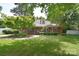 Charming brick home with a welcoming front porch and lush landscaping on a sunny day at 109 Larch Rd, Salisbury, NC 28147