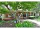 Inviting front porch with a seating area, plants, and a brick facade at 109 Larch Rd, Salisbury, NC 28147