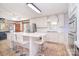A bright, remodeled kitchen features white cabinets, stainless steel appliances and a breakfast bar at 109 Larch Rd, Salisbury, NC 28147