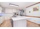 An updated kitchen features white cabinets, an island, and stainless steel appliances at 109 Larch Rd, Salisbury, NC 28147