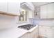 An updated kitchen features white cabinets, quartz countertops, and stainless steel appliances at 109 Larch Rd, Salisbury, NC 28147