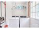 A bright laundry room with washer, dryer and storage at 109 Larch Rd, Salisbury, NC 28147