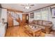 An open-concept living room features a wooden staircase and a plush leather sofa at 109 Larch Rd, Salisbury, NC 28147