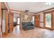 Spacious living room with hardwood floors, a stone accent wall, and access to the outdoors at 109 Larch Rd, Salisbury, NC 28147