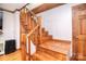 A wooden staircase with wood beam trim ascends in a room with neutral colored walls and floors at 109 Larch Rd, Salisbury, NC 28147