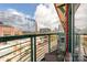 City view from balcony featuring a table, chair, and brick accents at 115 E Park Ave # 409, Charlotte, NC 28203