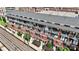 Aerial view of brick apartments with balconies near train tracks, showcasing a well-maintained property and landscaping at 115 E Park Ave # 409, Charlotte, NC 28203