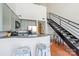 Modern kitchen with stainless steel appliances, breakfast bar, and a view of the staircase leading to the upper level at 115 E Park Ave # 409, Charlotte, NC 28203