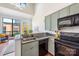 Cozy kitchen with green cabinets, granite countertops, and modern appliances, blending style and functionality at 115 E Park Ave # 409, Charlotte, NC 28203