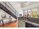 Well-lit kitchen with a modern staircase, breakfast bar, and sleek appliances, perfect for cooking and entertaining at 115 E Park Ave # 409, Charlotte, NC 28203