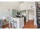 Charming kitchen with pale green cabinets, stainless steel appliances, and bar seating for a modern touch at 115 E Park Ave # 409, Charlotte, NC 28203